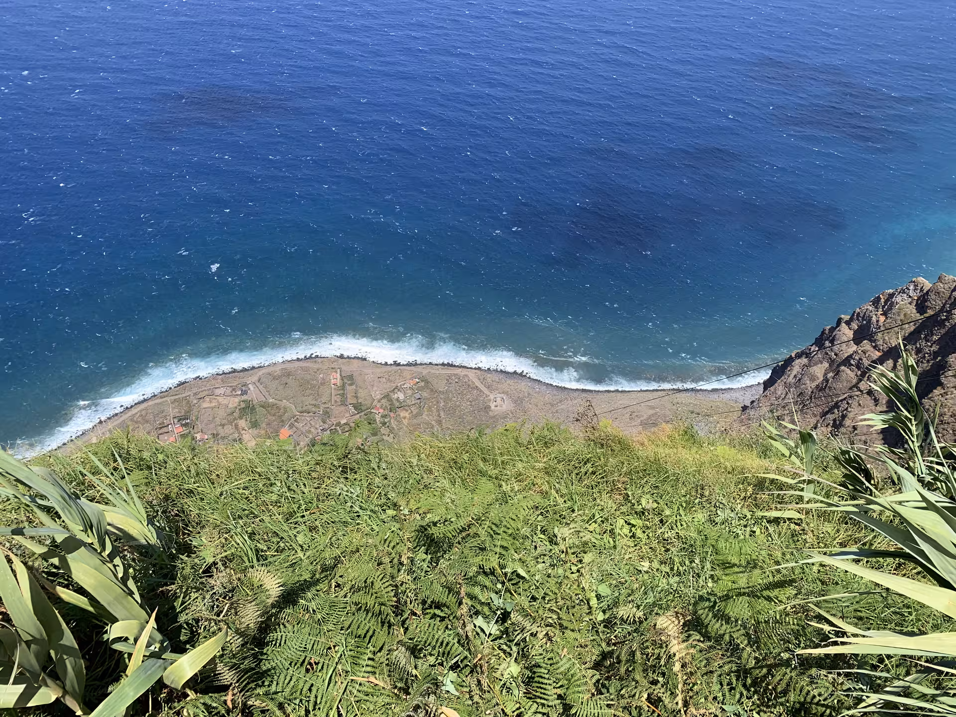 Stunning aerial cliffside view of Madeira's rugged coastline and deep blue Atlantic Ocean on a private guided tour