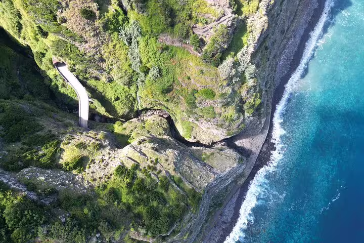 Aerial view of Madeira's stunning coastal cliffs and lush greenery on a 4x4 off-road adventure tour.