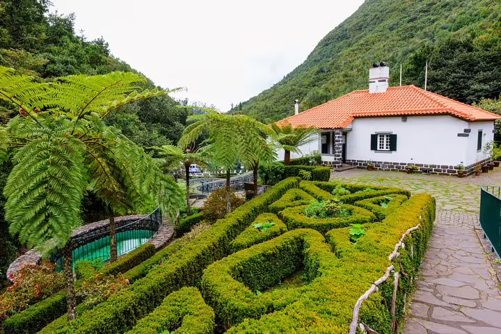 Charming Madeira house with lush gardens and mountain backdrop on the Full Day East of Madeira Tour.