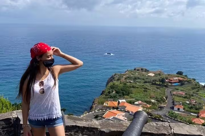 Visitor enjoying panoramic views of Madeira's coastline, highlighting lush landscapes and ocean vistas for a 2-day tour.