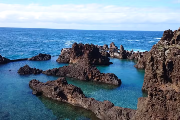 Crystal-clear natural lava rock pools along Madeira's rugged Atlantic coastline visited on a full-day guided tour