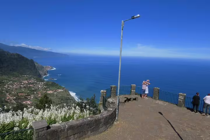 Visitors admire breathtaking ocean vistas from a scenic viewpoint on the Madeira Northeast 4x4 tour.