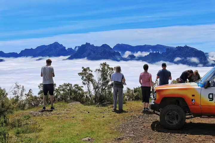 A group enjoys stunning mountain views above the clouds on a 4x4 adventure tour exploring Madeira's northwest frontier.