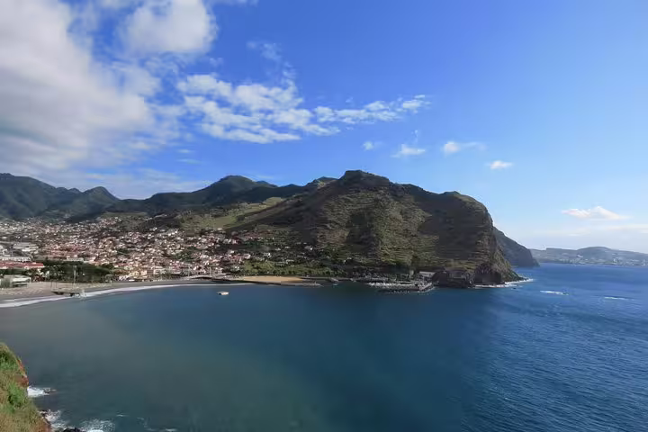 Scenic view of Madeira's coastline and peaks under a blue sky, perfect for an exhilarating open 4X4 full-day adventure tour.