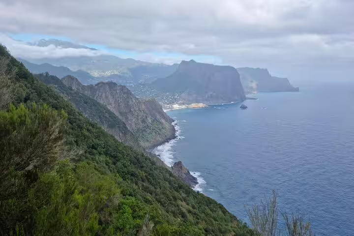Scenic coastal view of Madeira's lush greenery and cliffs along the Porto da Cruz to Machico hiking trail.