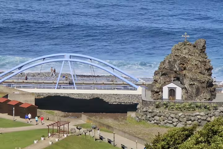 Scenic view of Madeira's coastal bridge and chapel near the ocean, ideal for the Enchanted Terraces & Fanal UNESCO jeep tour.