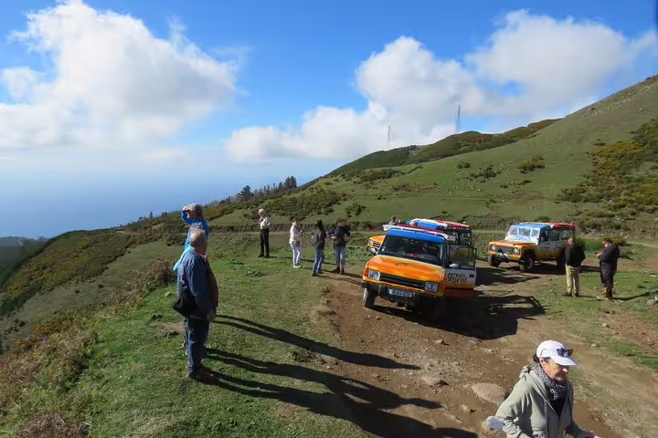 Tourists enjoy breathtaking views on a Madeira West open-top jeep tour through Enchanted Terraces and Fanal UNESCO site.