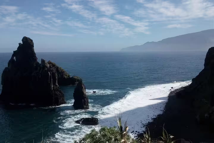Dramatic rock formations rising from the Atlantic Ocean along Madeira's west coast, showcasing stunning natural beauty.