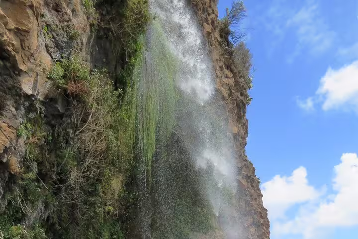 Cascading waterfall over a rocky cliff in Madeira's southwest, perfect for a scenic 4x4 guided exploration adventure.