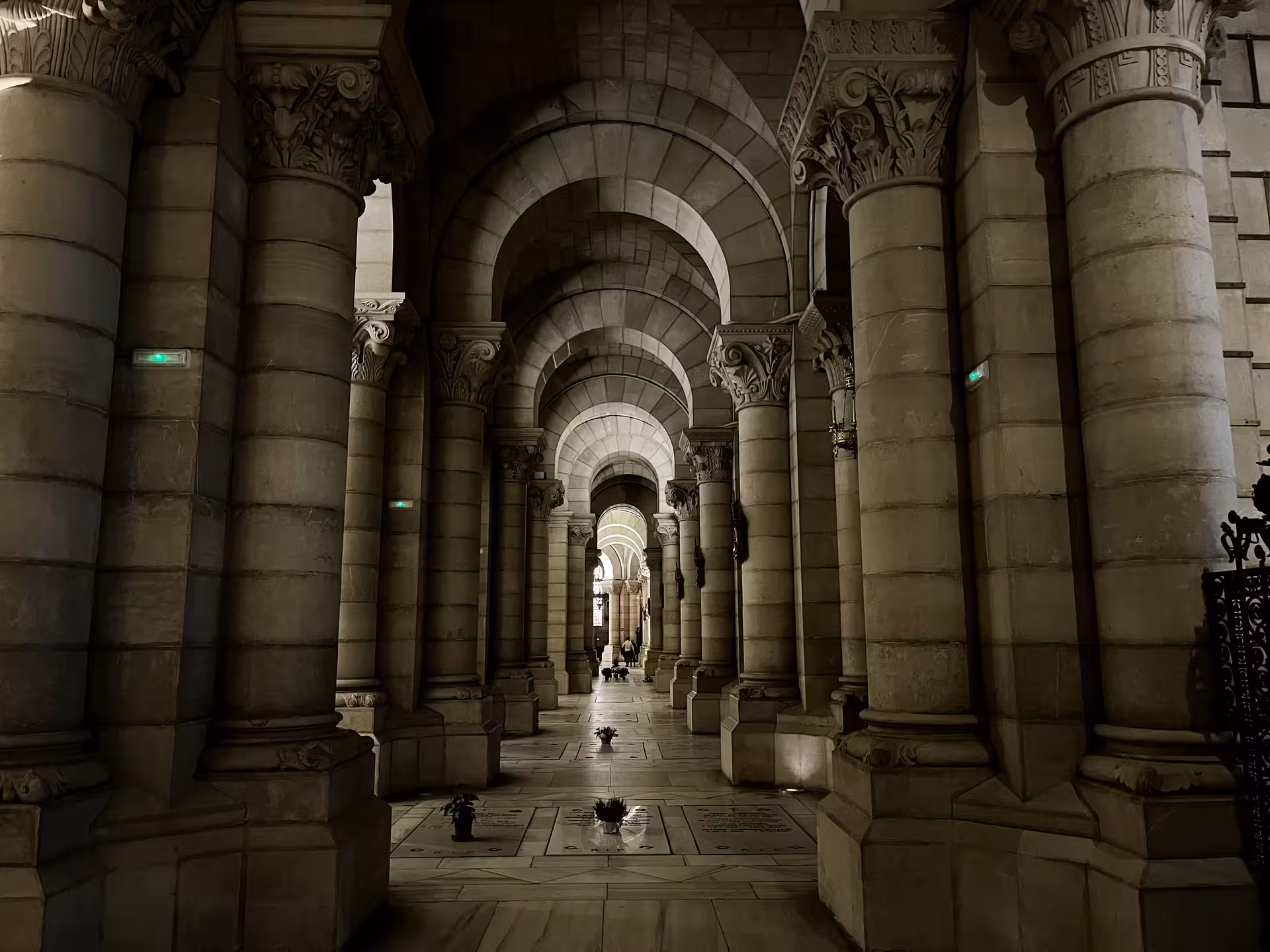 Arched stone colonnade inside Madrid’s Almudena Cathedral, part of the MADRID Historias Locales tour