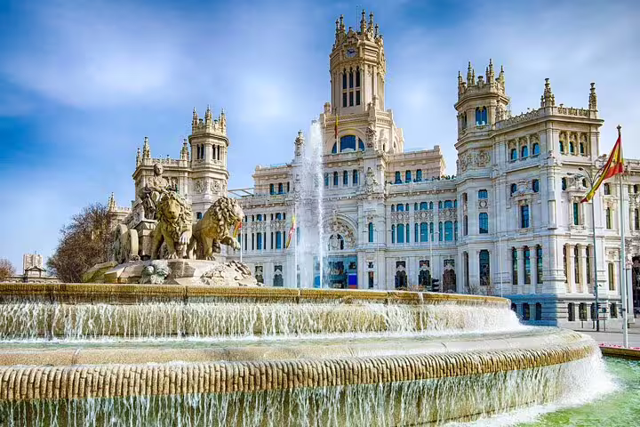 Cibeles Fountain and Palace in Madrid with ornate architecture and Spanish flag