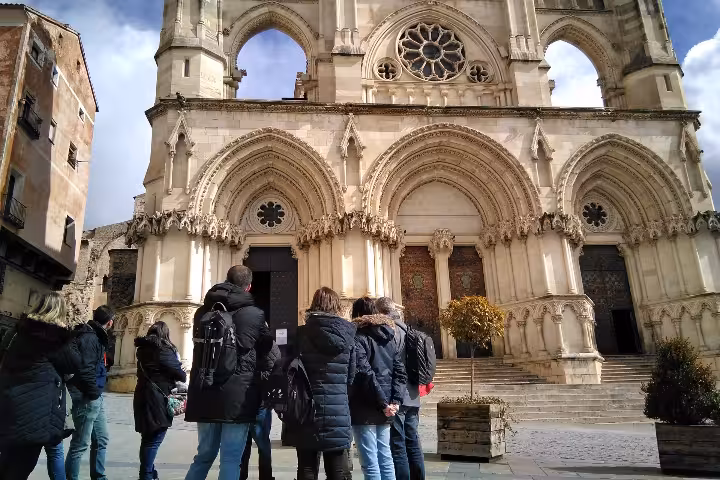 Guided day trip from Madrid to Cuenca with Cathedral admission, travelers viewing the Gothic facade