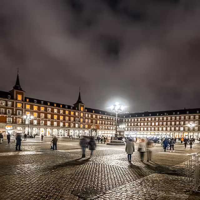 Evening crowd in Plaza Mayor Madrid under lamplights, part of MADRID Misterios Locales + Wax Museum tour
