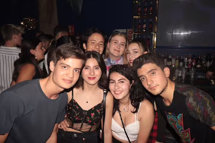 Happy friends gathered at a bar during a Madrid pubcrawl, showcasing the energetic and social nightlife scene.