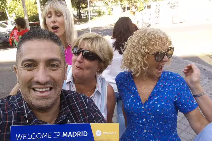 Friendly guide greeting guests in Madrid for private day trip to Toledo, small group selfie at pickup spot