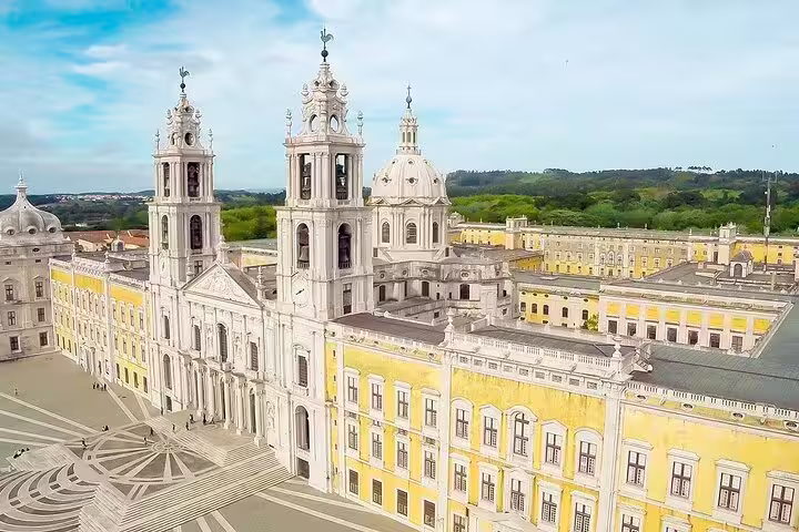 Aerial view of the grand Mafra Palace with its baroque architecture, a highlight of the Mafra, Ericeira, and Queluz tour from Lisbon.