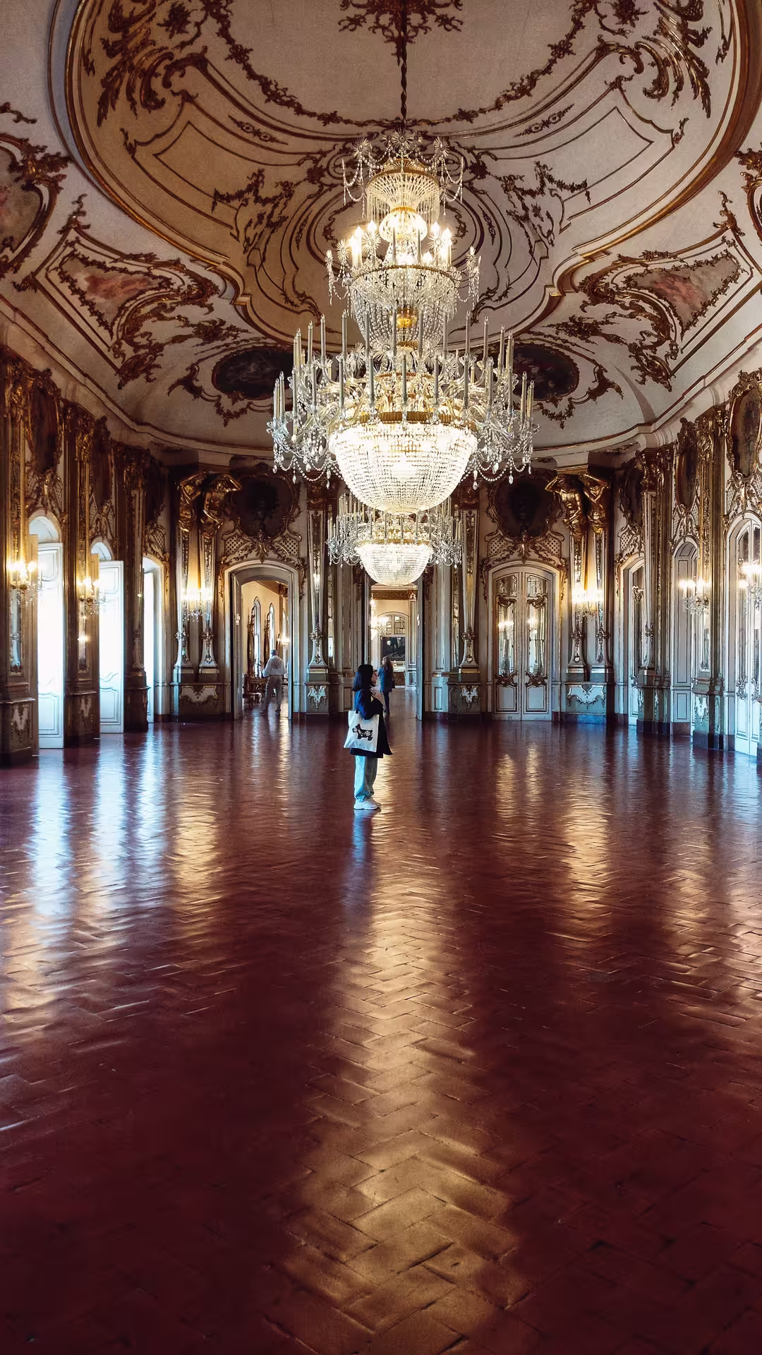 Lavish palace interior with ornate chandelier and elegant decor on the Mafra, Ericeira, Queluz private full-day tour.