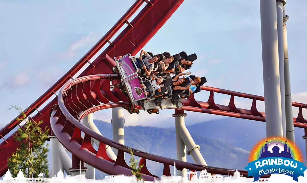 Thrilling MagicLand roller coaster ride with riders on a red track, top attraction with park entry tickets