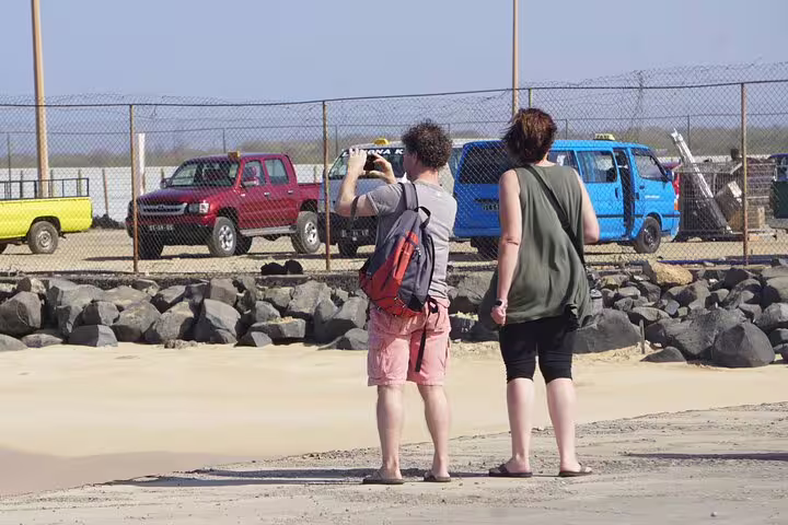 Travelers near Maio Airport parking, Cape Verde, awaiting private transfer from airport to Morro in comfortable vehicle