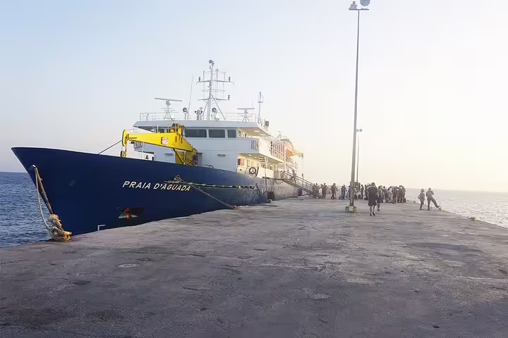 Large ferry docked at Maio harbour under a clear sky, facilitating seamless private transfers to Vila do Maio.