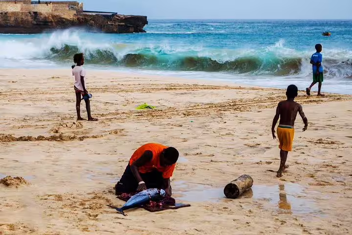 Fishermen on Maio Island beach with Atlantic waves, a highlight of the guided Maio Island tour with lunch