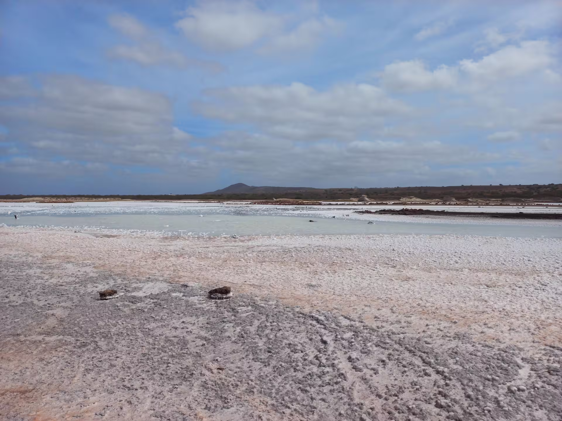 Expansive salt flats under a bright blue sky on Maio Island, ideal for exploration on a guided tour.
