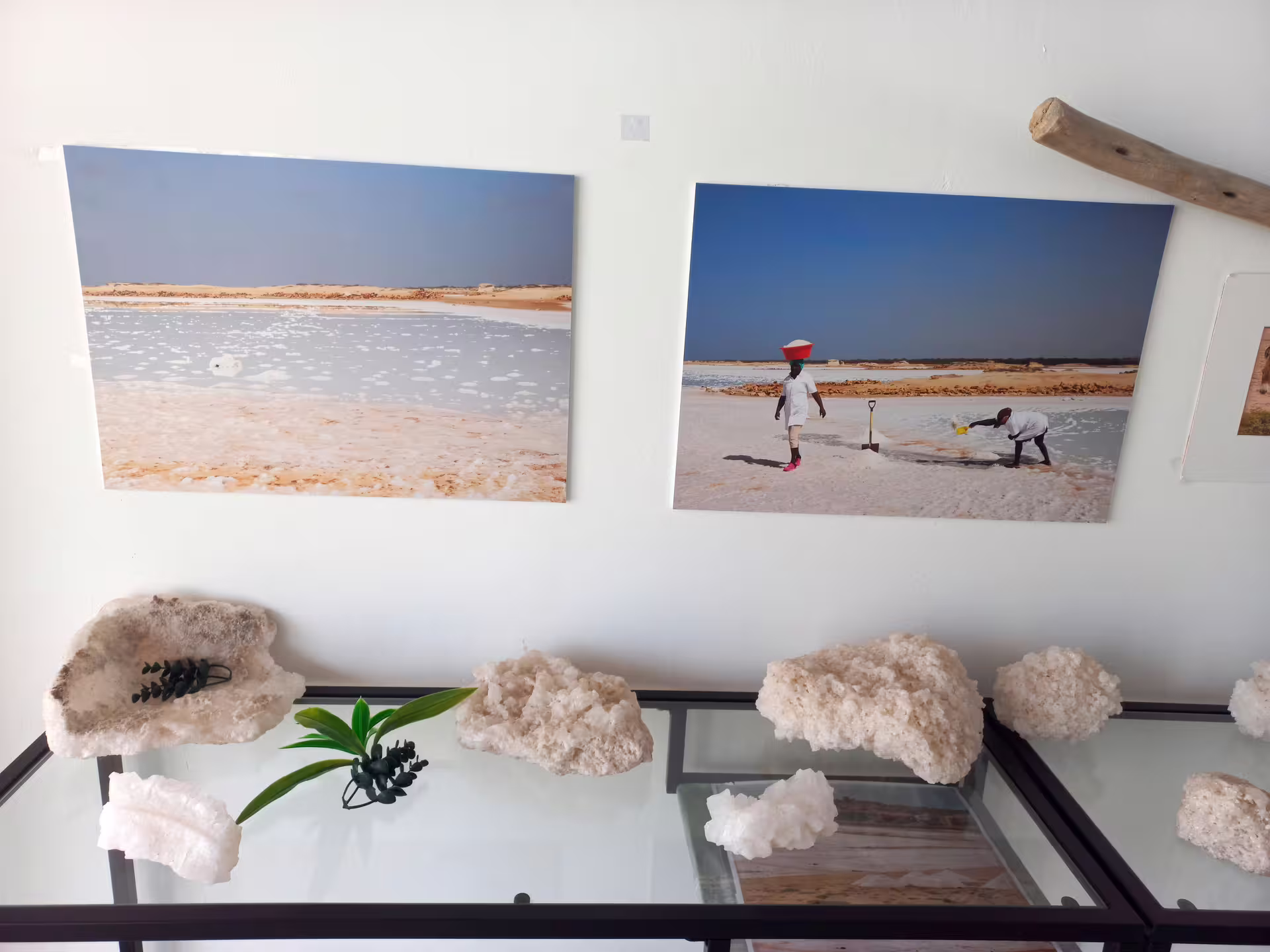 Salt crystals and photos of salt pans displayed in a cultural exhibit on Maio Island tour.