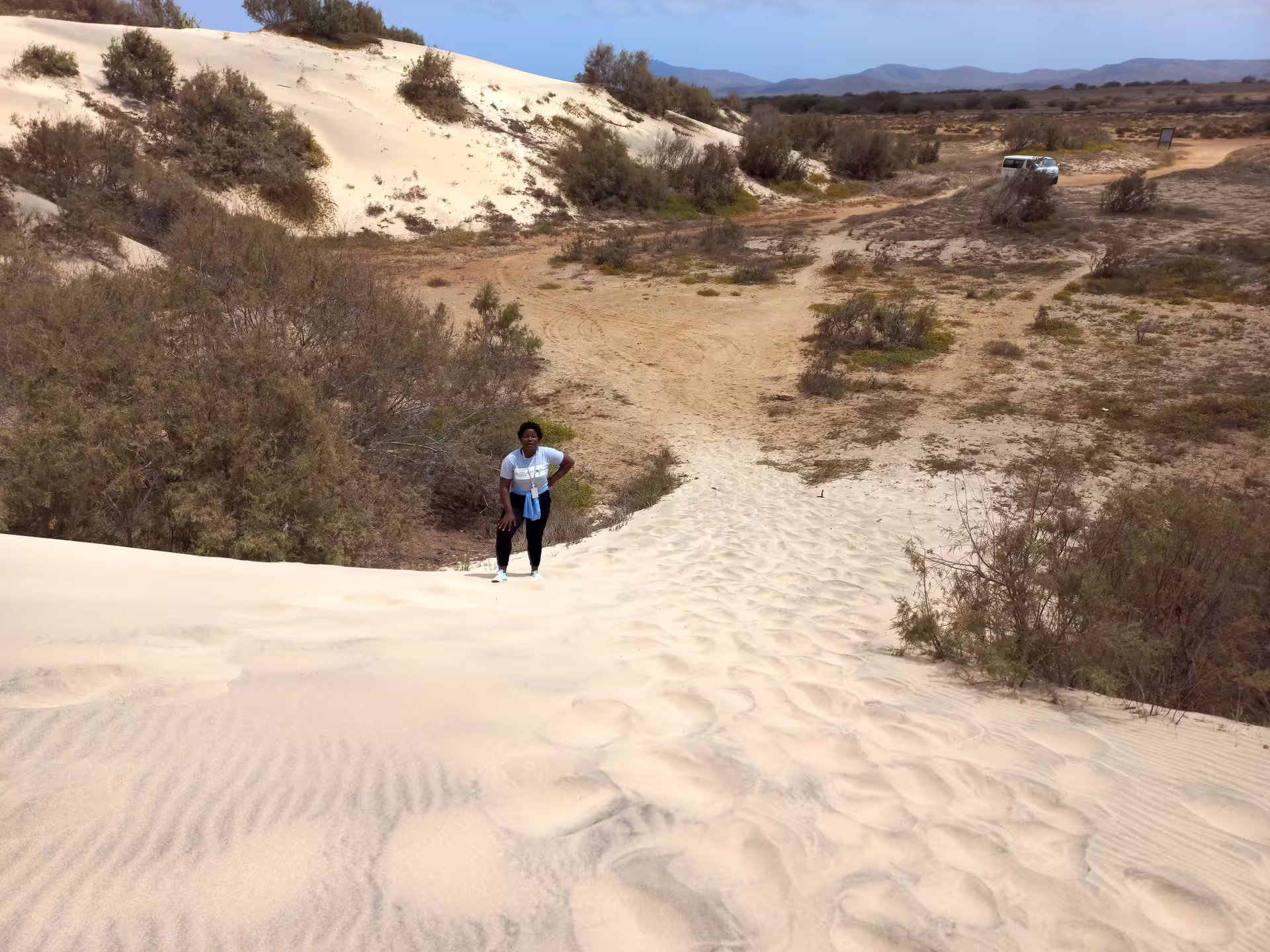 Traveler exploring the sandy dunes of Maio Island, Cape Verde, during a guided full-day private tour.