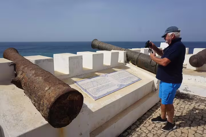 Traveler photographing historic cannons on Maio island, easy private transfer between harbour and Calheta hotels