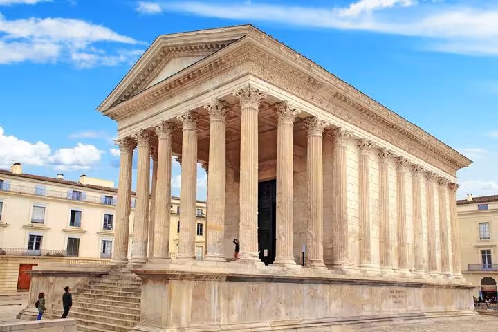 Maison Carrée Roman temple with Corinthian columns in Nimes, France on a sunny day
