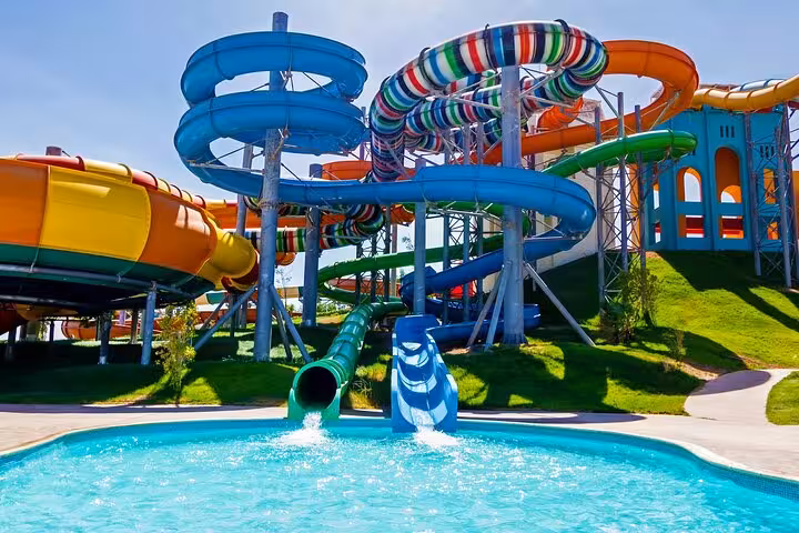 Colorful twisting water slides at Makadi Water World Aqua Park day use with pool, Hurghada transfer