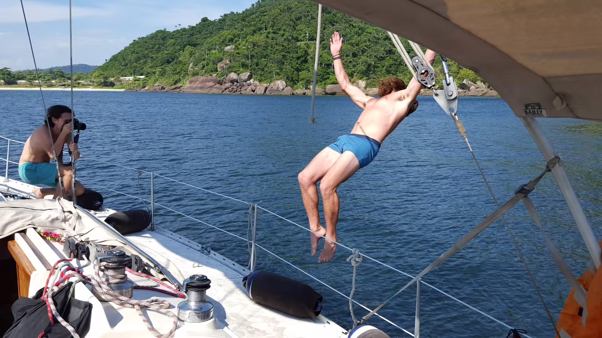 Man capturing a thrilling jump off the MAKANI MAIKAI yacht during a scenic private sailing tour.