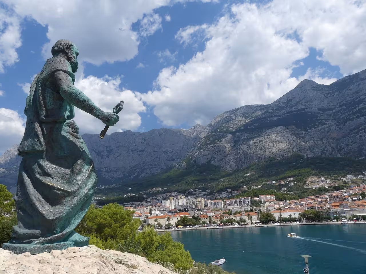 Makarska waterfront statue with Biokovo Mountain backdrop, scenic stop on Split to Skyline cliffview tour