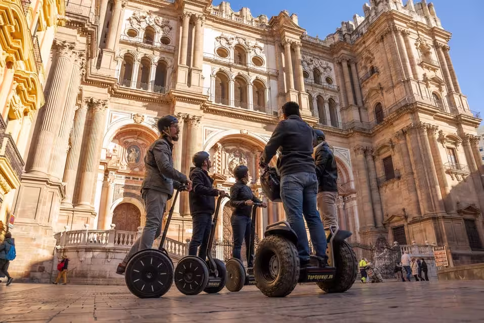 Tourists on Segways explore Malaga Cathedral during a one-hour panoramic city tour.