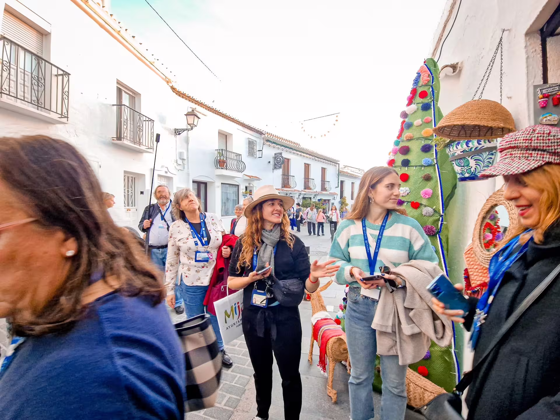 Guests browsing crafts in whitewashed Mijas village street on a private Malaga and Mijas full day trip with hotel pickup