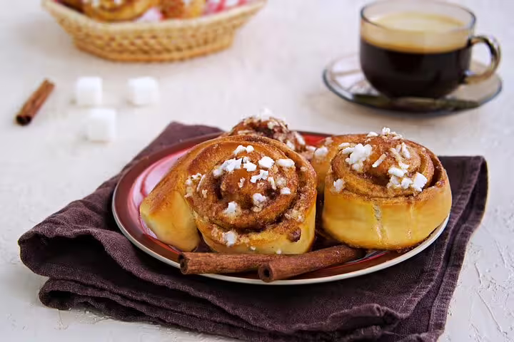 Swedish fika experience with cinnamon buns and coffee showcased during the Malmö private full day trip from Copenhagen by train.