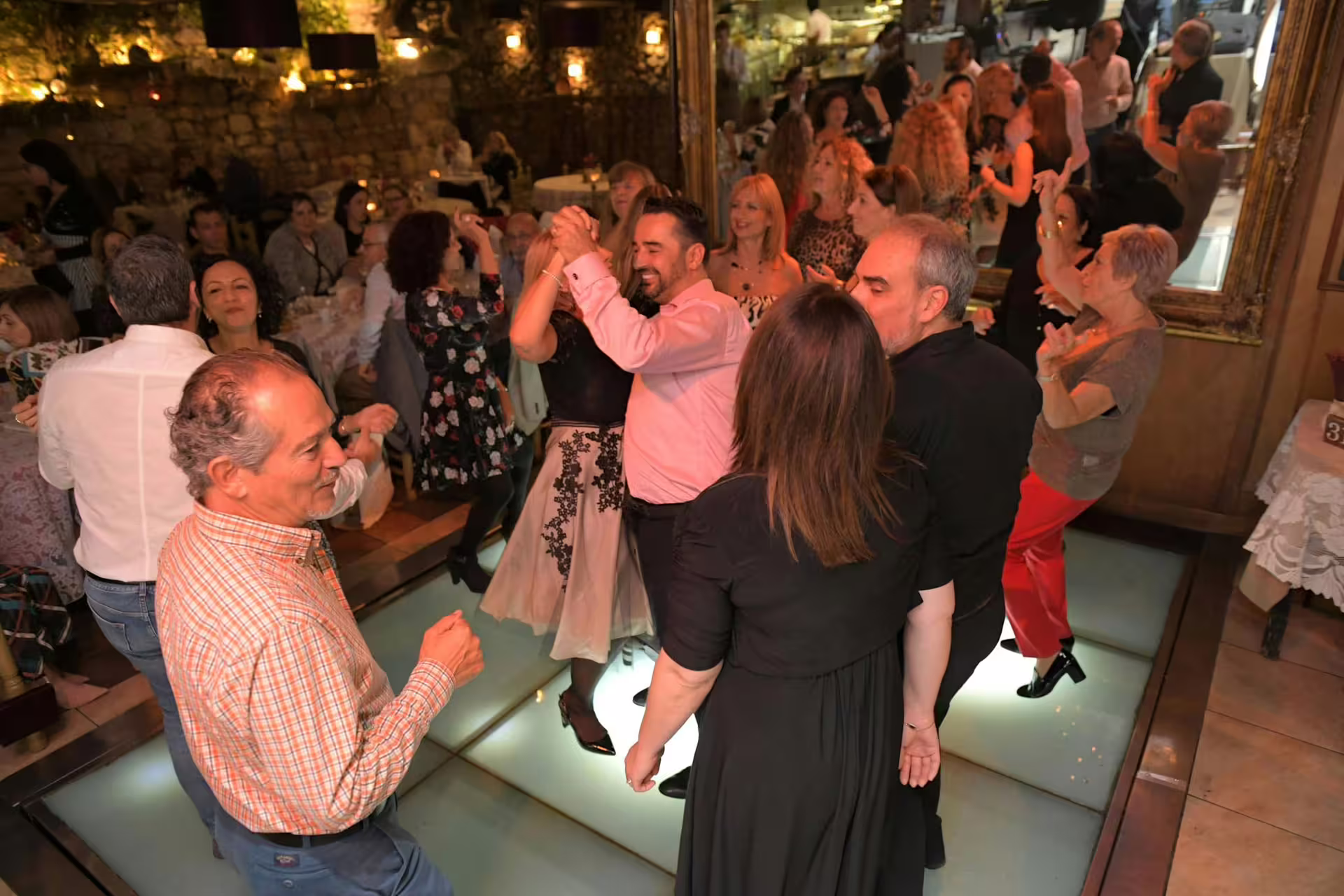 Guests enjoy dancing at a lively Maltese Folklore Night Tour with traditional music and vibrant ambiance.