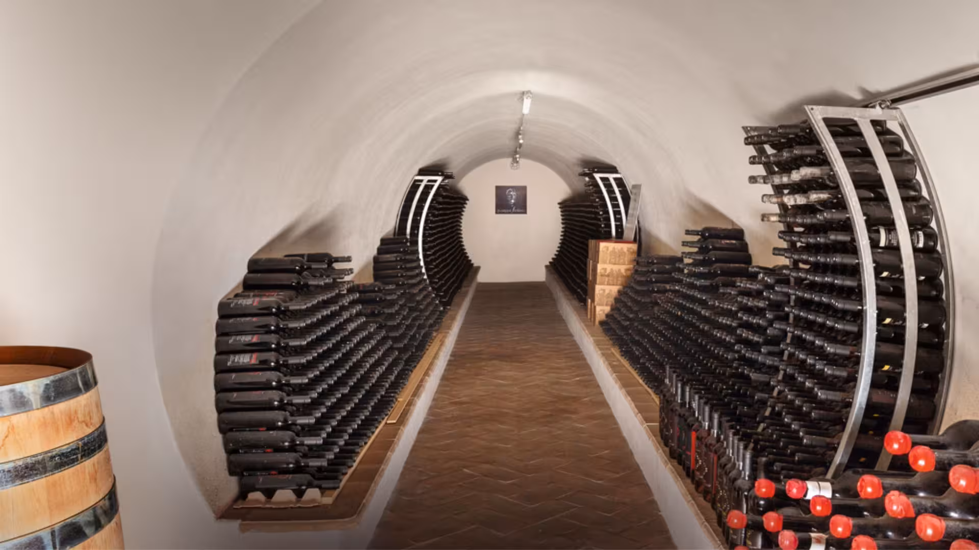 Explore the atmospheric wine cellar in Mamoiada, showcasing rows of fine wine bottles for tasting tours.