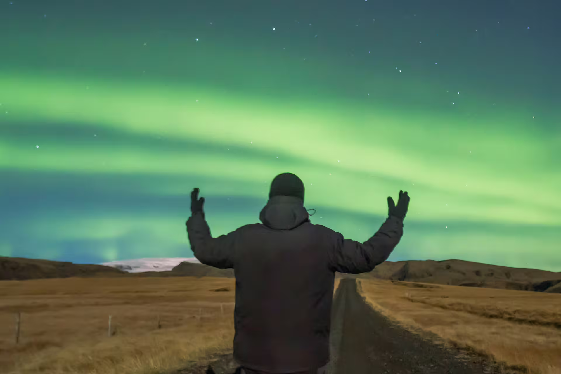 A man standing under the auroras in Iceland