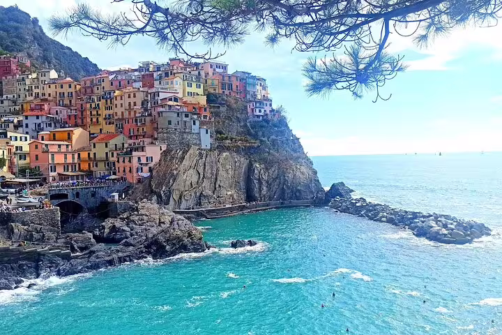 Manarola village in Cinque Terre perched on dramatic sea cliffs above turquoise Ligurian waters on a private day tour