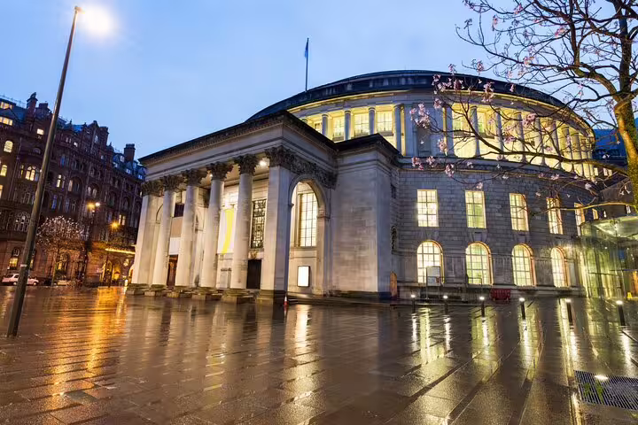 Manchester Central Library lit at twilight, highlight on a self guided audio tour and scavenger hunt walk
