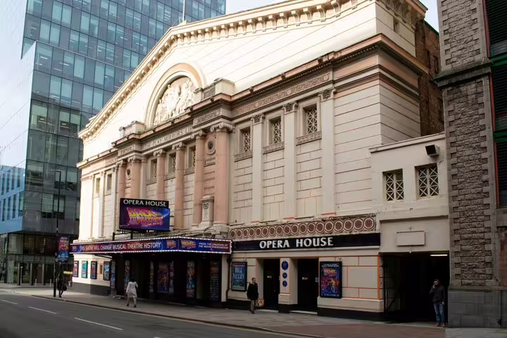 Manchester Opera House theatre facade with Back to the Future musical marquee on busy city street