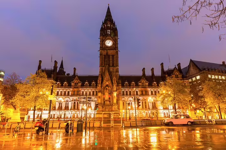 Manchester Town Hall at dusk, key stop on a self guided audio tour and scavenger hunt in city centre