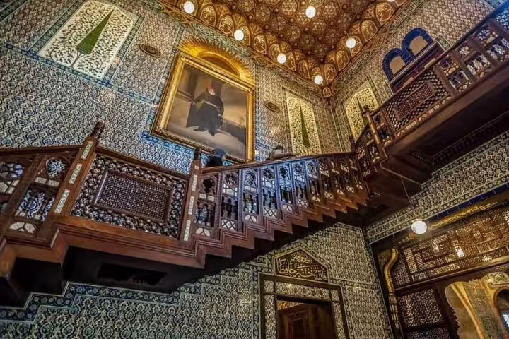 Manial Palace staircase in Cairo with intricate tilework, carved wood balcony and historic royal decor tour