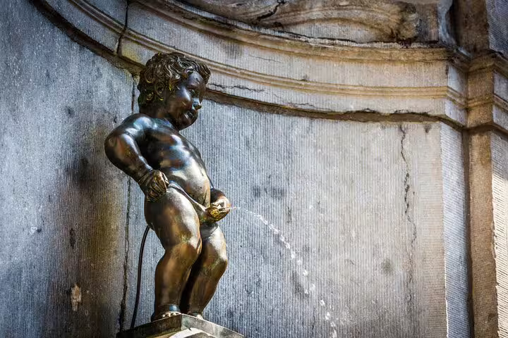 Manneken Pis statue in Brussels, a must-see highlight on the private tour with a beer stop, showcasing the city's charm and history.