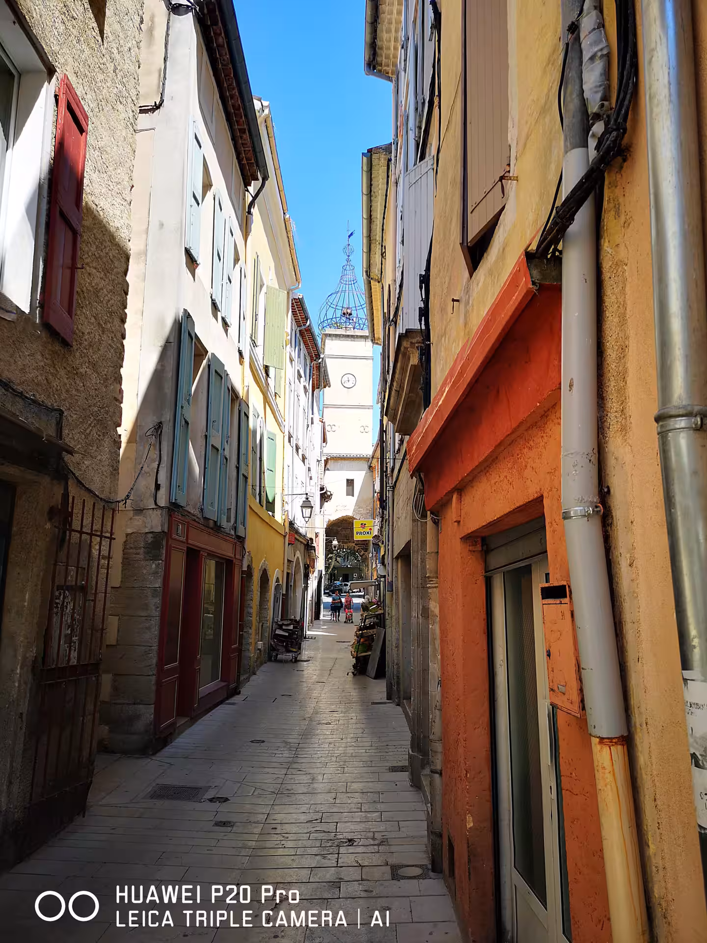 Narrow lane with pastel shutters in Manosque, Provence, featured on Marseille private shore excursion tour