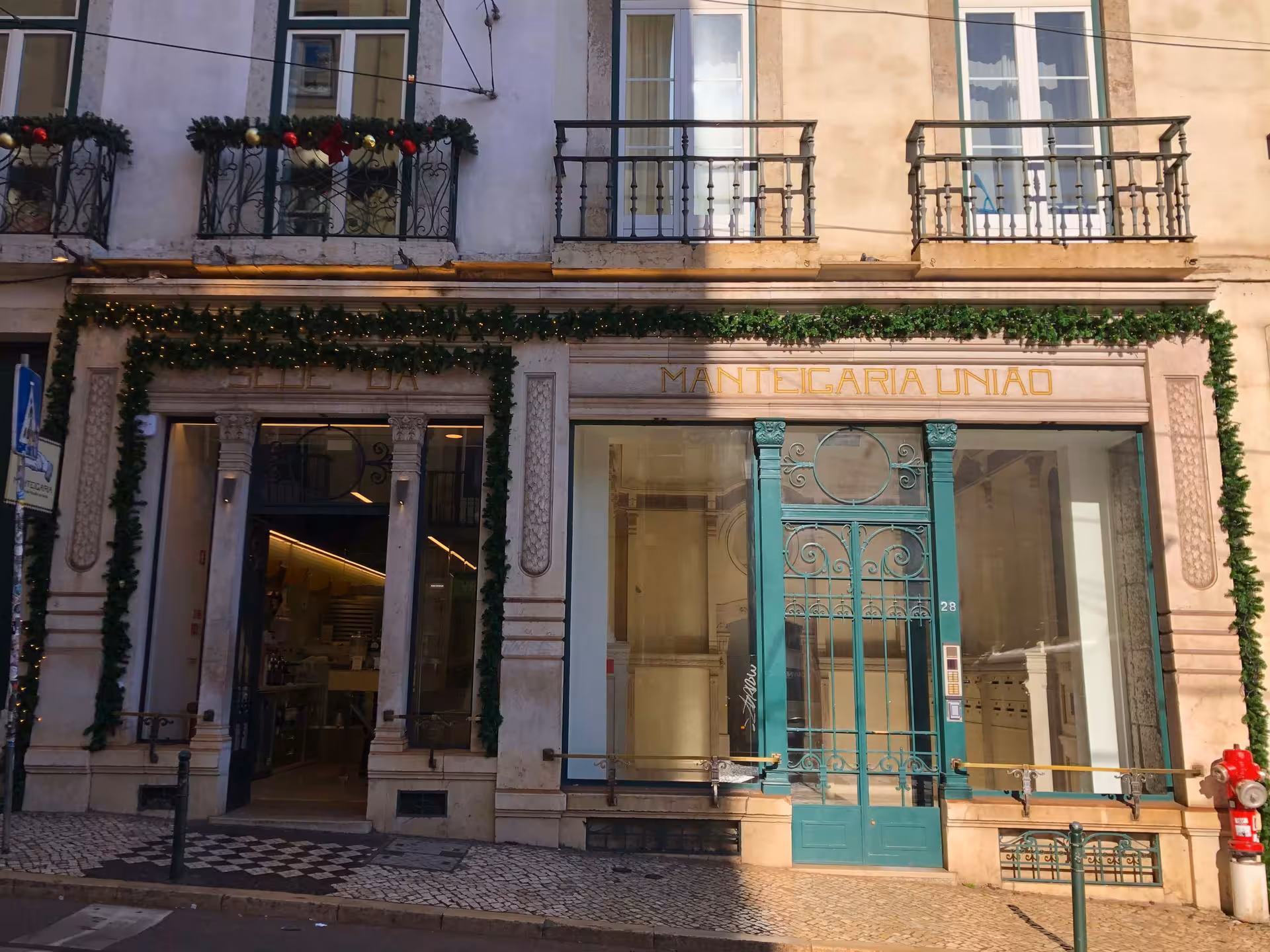 Manteigaria União historic Lisbon shopfront with teal iron gate, featured on the Old Shops, Traditions & Stories tour