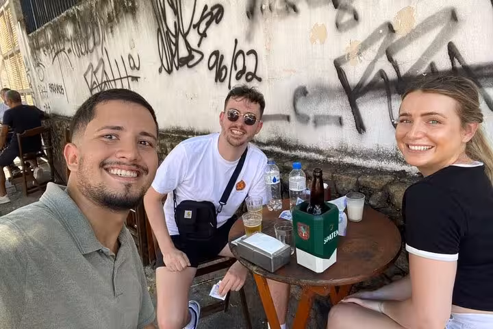 Local guide and travelers enjoy drinks before a Maracanã Stadium tour in Rio de Janeiro