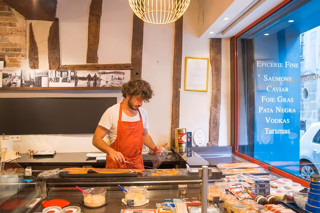 Tour participant exploring gourmet delicacies in a charming Marais shop on a food walking tour.