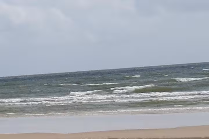 Waves rolling onto a wide sandy beach on Marajó Island, Pará, Brazil, on a 2D1N island getaway tour